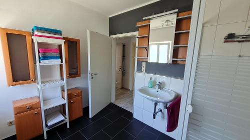 a small bathroom with a sink and a mirror at Ferienwohnung Ollywood, Natur pur im Westerwald, 2 bis 4 Personen 