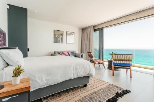 a bedroom with a bed and a view of the ocean at Beyond Misty Cliffs in Scarborough