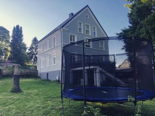 a house with a mirror in front of a house at Mein Eifel Ferienhaus Altes Pfarrhaus in Dahlem