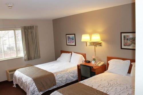 a hotel room with two beds and a telephone at Edmore Inn in Edmore