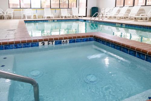 a large swimming pool with chairs in a building at Comfort Inn & Suites Near Medical Center in San Antonio