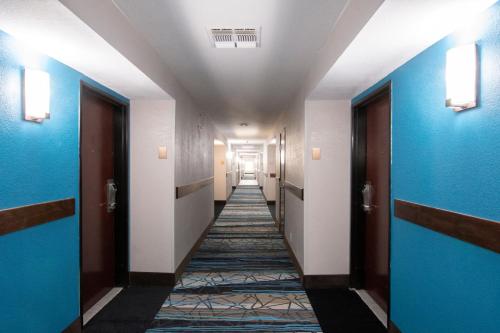 a hallway with blue and white walls and a long corridor at Comfort Inn & Suites Near Medical Center in San Antonio