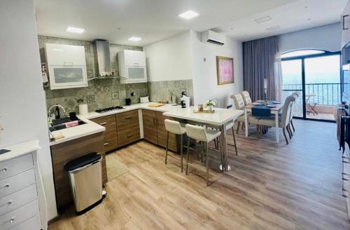a kitchen with a table and chairs and a dining room at Beach front High End apartment, direct sea views. in Marsalforn
