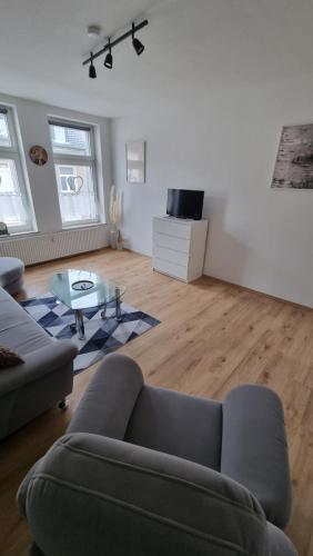 a living room with a couch and a glass table at FeWo Resse in Gelsenkirchen
