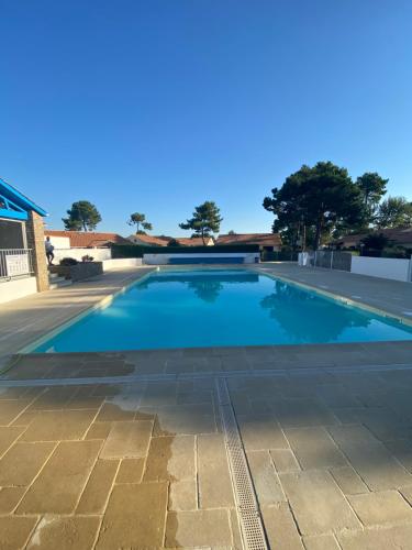 une grande piscine avec de l'eau bleue dans l'établissement Maisonnette hameau des pins, à Saint-Jean-de-Monts