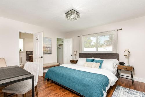 a bedroom with a large bed and a table at New! Tropical Escape in Pompano with private heated Pool, Spa, and Covered Pergola in Pompano Beach