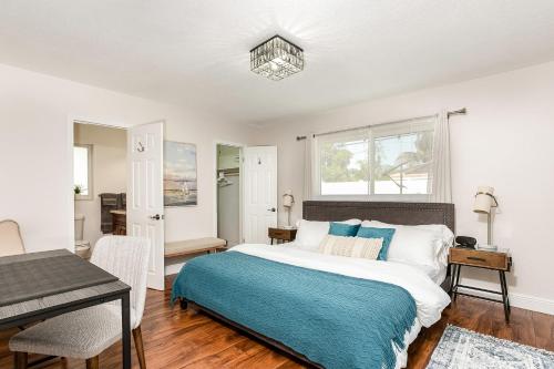 a bedroom with a large bed and a table at Pompano home with private heated Pool 3D tour available in Pompano Beach