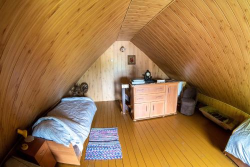a room with a bed and a dresser in a attic at Agroturystyka u Wojtka in Teremiski