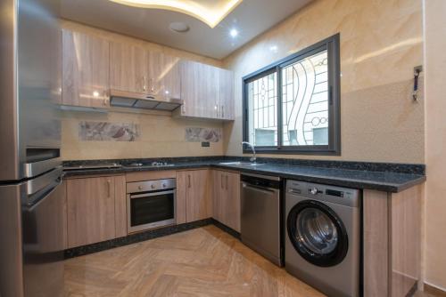 a kitchen with a washer and dryer in it at Adam's Apartments,Self CheckIn 6 Mins to Beach Downtown Fiber Optic WiFi Free Parking Same Rules as Hotels in Agadir