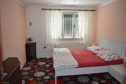 a small bedroom with a bed and a window at Penzion243 in Tábor