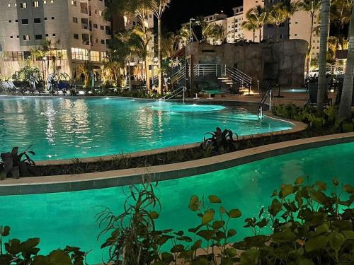 a large swimming pool in a city at night at Salinas Premium Resort in Salinópolis