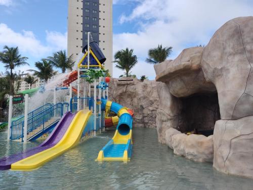 a water park with a water slide in the water at Salinas Premium Resort in Salinópolis