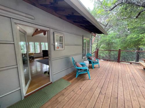 a porch of a house with two chairs on it at The Rivery Retreat, Choose from Luxury Guesthouse Cabin OR Poolside Suite in Lake Austin Hill Country in Austin