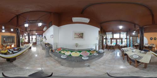 a large room with tables and chairs in a building at Quari Quara BY MN Hotéis in Rio das Ostras