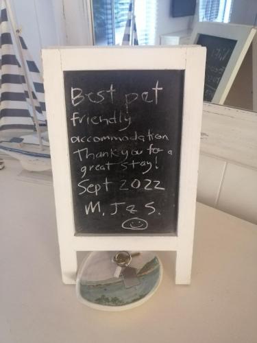 a chalkboard sign with a ring on top of it at Sapphire Beach Pet Friendly Beach 5 minute walk in Sapphire Beach