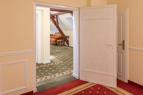 an open door into a hallway with a room at Robenstein Hotel & SPA - Villa in Zwiesel