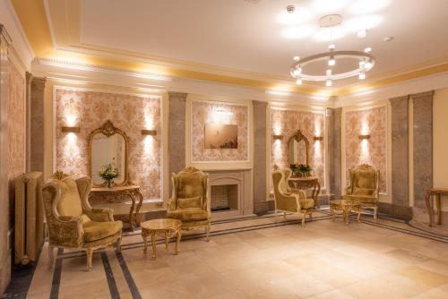 a living room with chairs and a fireplace at Robenstein Hotel & SPA - Villa in Zwiesel