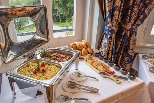 a buffet of food and bread on a table at Robenstein Hotel & SPA - Villa in Zwiesel