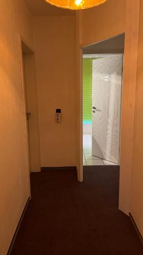 a hallway with a white door and a green wall at smart&beautiful Guesthouse in Nordkirchen