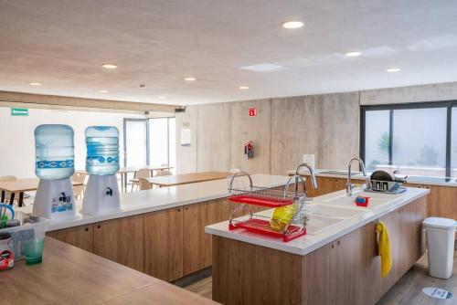 a kitchen with two water bottles on a counter at +MS +Loft Coworking +Vigilancia 24hrs +Internet 504 in Laborcillas
