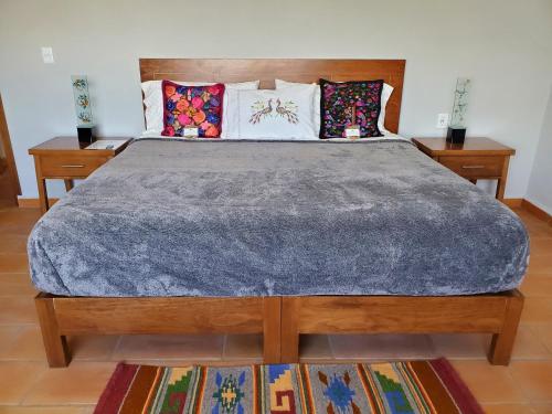 a bedroom with a large bed with two night stands at Casa de Tillie in Guanajuato