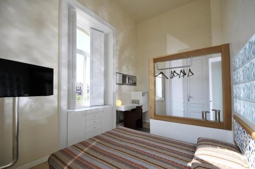 a bedroom with a bed and a mirror and a sink at Villa Battista in Ercolano