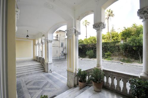 an arcade of a building with potted plants at Villa Battista in Ercolano
