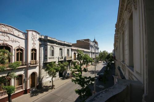 an empty street in a city with buildings at Happy House Hostel in Santiago