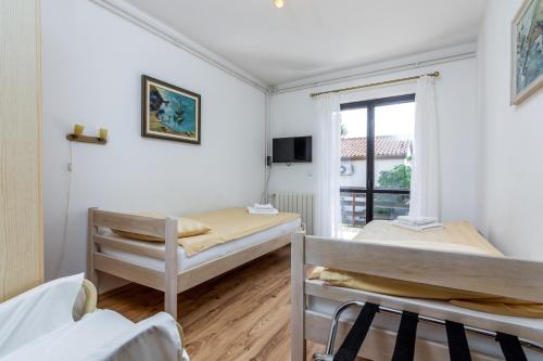 a bedroom with two bunk beds and a window at Apartments with parking space Pjescana Uvala, Pula - 7349 in Pula