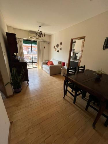 a living room with a table and a couch at Santiago 700 in San Miguel de Tucumán