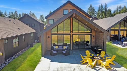 a house with a patio with yellow chairs and tables at Suncadia Resort Luxury Home Next To Nelson Farm in Cle Elum