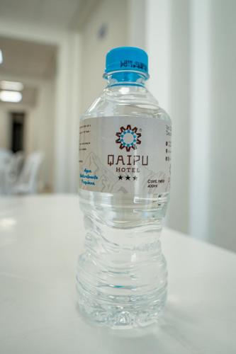 a bottle of water sitting on a table at QAIPU HOTEL in Puquio