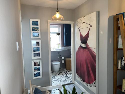 a dress hanging on a wall in a room at Sea Facing 2BD Terraced Home - Peacehaven in Peacehaven