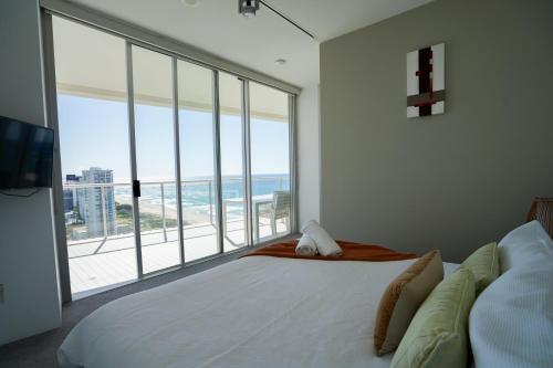 a bedroom with a large bed with a view of the ocean at Air On Broadbeach-Stunning Ocean Views in Gold Coast