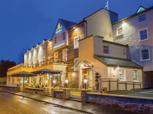 a building with a restaurant on the side of a street at Busby Hotel in Busby
