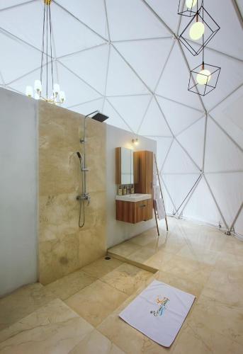 a large bathroom with a shower and a sink at Coconut Galaxy Villas by Bali Cabin in Dalung