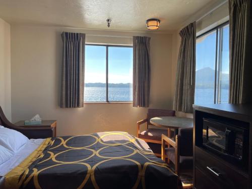 a hotel room with a bed and a view of the water at Super 8 by Wyndham Ketchikan in Ketchikan
