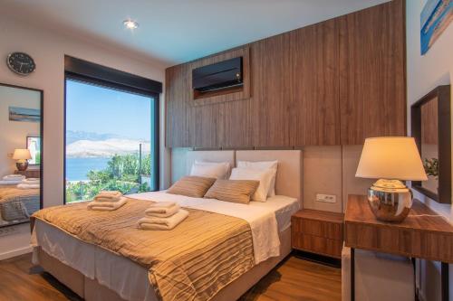 a bedroom with a large bed with a large window at Luxury villa with a swimming pool Bosana, Pag - 19824 in Pag