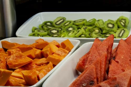 two plastic trays of food with fruit and vegetables at Américas Granada Hotel in Rio de Janeiro