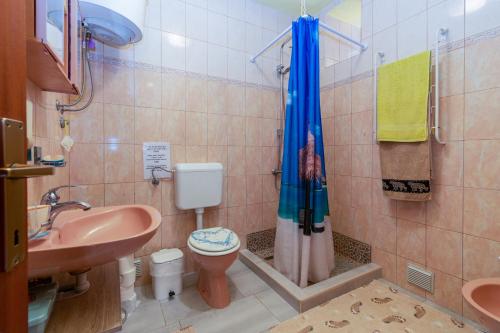 a bathroom with a sink and a toilet and a shower at Apartments by the sea Punat, Krk - 19831 in Punat