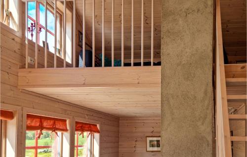 a staircase in a house with wooden walls at 3 Bedroom Amazing Home In Vikeså in Vikeså