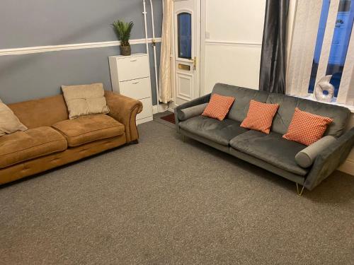 a living room with two couches and a couch at The Vacationers - Pvt Rooms with Shared Bath in Sunderland