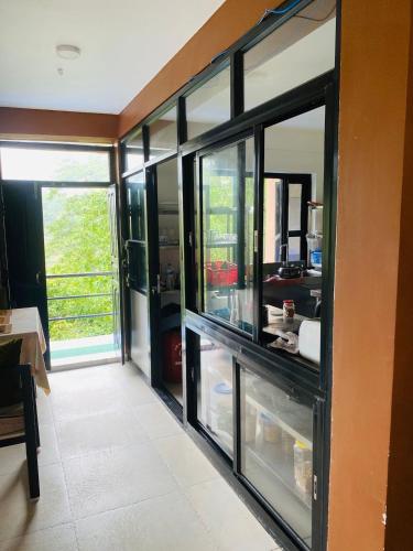 a kitchen with glass doors and a counter with food at Hotel Aagaman - Best Family Hotel in Bandipur in Bandīpur