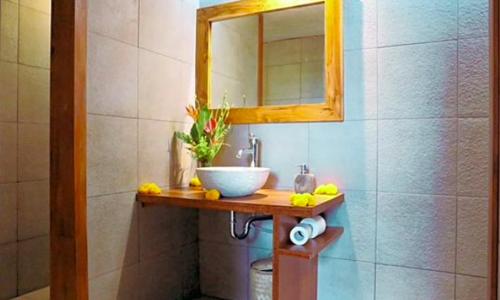 a bathroom with a sink and a mirror at Village Above The Clouds in Bedugul