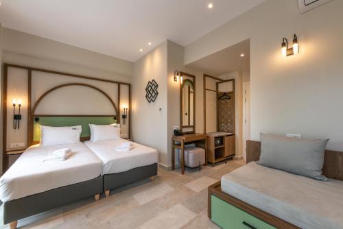 um quarto de hotel com duas camas e uma secretária em El Greco Hotel em Chania Town