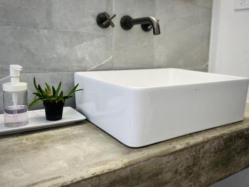 a white sink sitting on a counter in a bathroom at Lejos Eco Retreat in Vieques