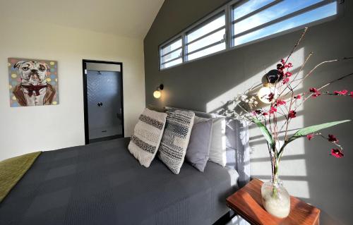 a bedroom with a bed with a vase of flowers on a table at Lejos Eco Retreat in Vieques