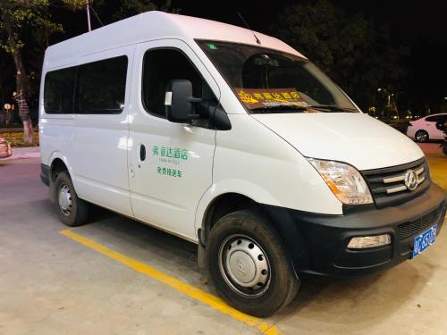 a white van parked in a parking lot at Frida Hotels Guangzhou Baiyun International airport in Guangzhou