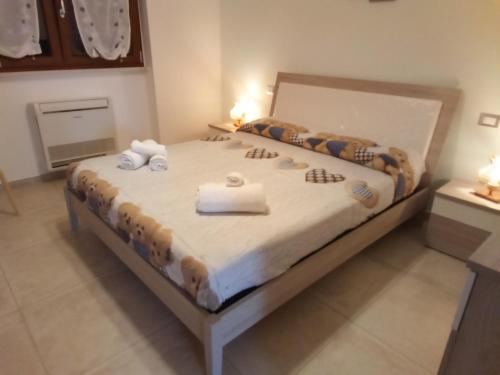 a bedroom with a bed with towels on it at Villa Anna Maria in Polignano a Mare