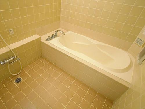 a bathroom with a bath tub in a room at グリーンヒル　大人専用 in Yoshioka